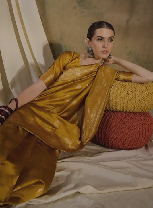 Woman relaxing wearing mustard silk saree